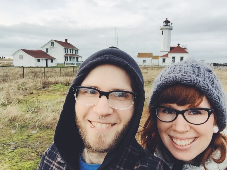 selfie of couple with fort worden lighthouse in background